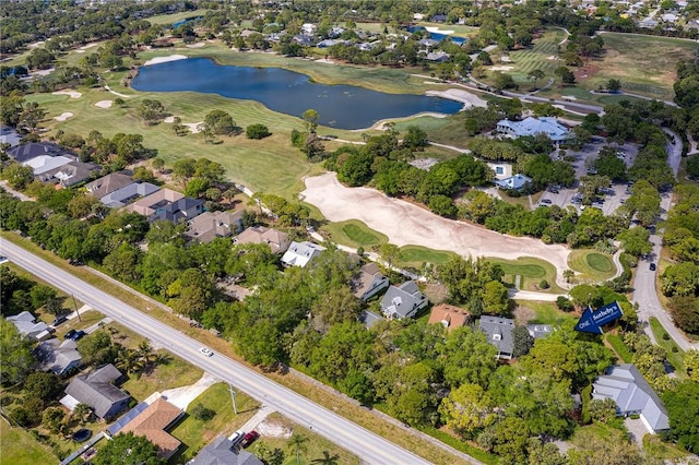 birds eye view of property featuring view of golf course, a water view, and a residential view