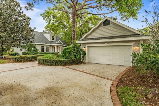 view of front of property featuring a shingled roof, a garage, and stucco siding