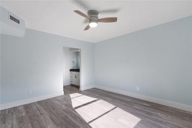 12 Plantation Dr Unit 104, Vero Beach, FL 32966 - spare room with wood finished floors, a ceiling fan, and baseboards