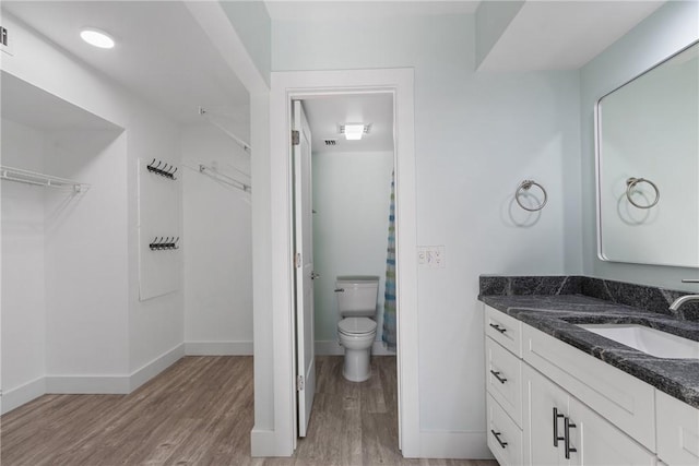 12 Plantation Dr Unit 104, Vero Beach, FL 32966 - bathroom featuring wood finished floors, vanity, and baseboards