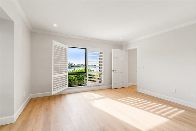 unfurnished room featuring crown molding and light hardwood / wood-style floors