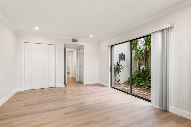 unfurnished bedroom with access to outside, crown molding, a closet, and light hardwood / wood-style floors