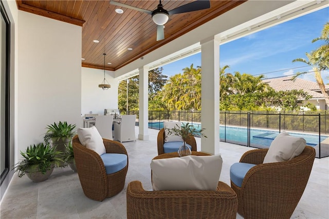 view of patio featuring ceiling fan and a fenced in pool