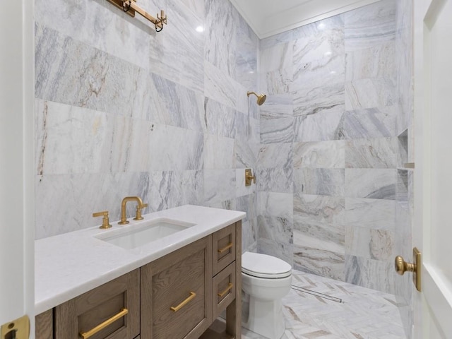 bathroom with toilet, a shower, vanity, and tile walls