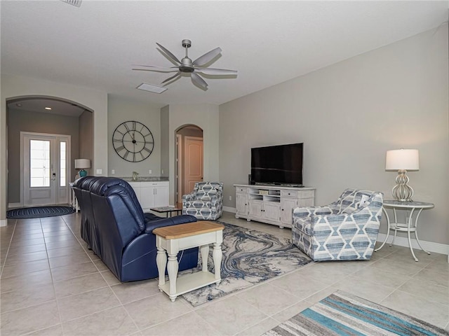 tiled living room with ceiling fan