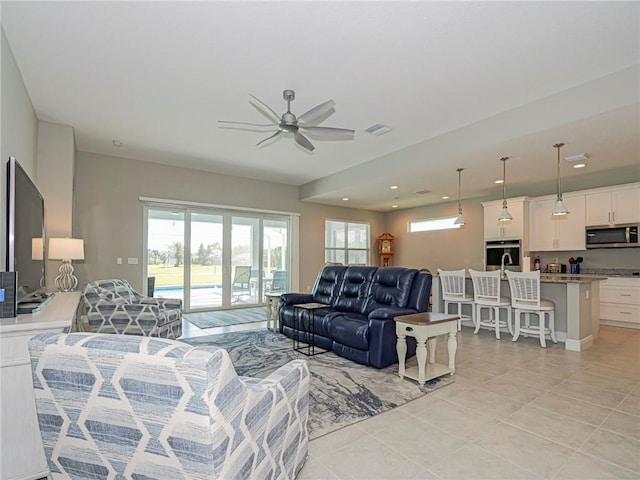 tiled living room with ceiling fan