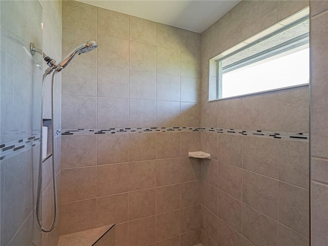 bathroom with tiled shower