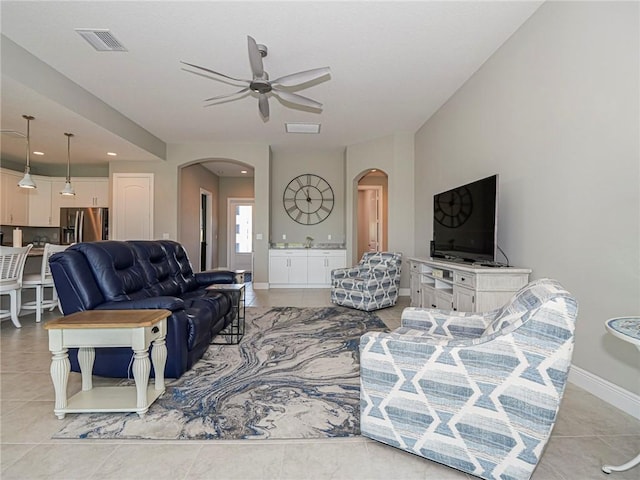 tiled living room with ceiling fan