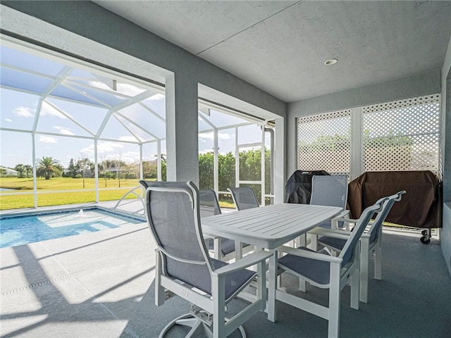 sunroom / solarium featuring a healthy amount of sunlight and a pool