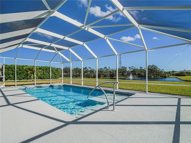 view of swimming pool with glass enclosure, a patio area, and a water view