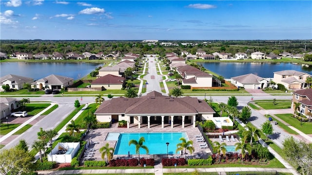 bird's eye view featuring a water view and a residential view