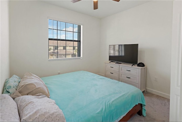 bedroom featuring light carpet, ceiling fan, and baseboards