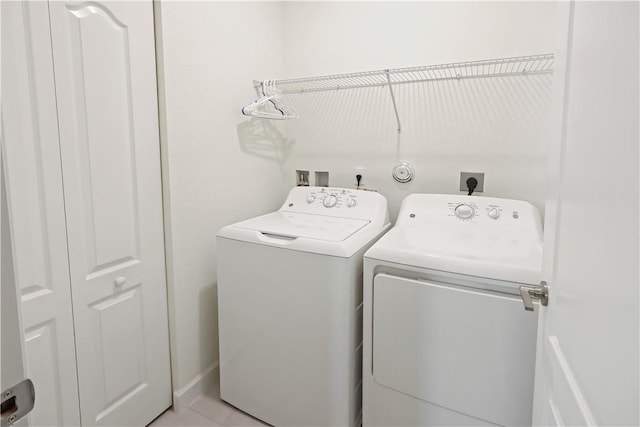 clothes washing area with laundry area and washer and clothes dryer