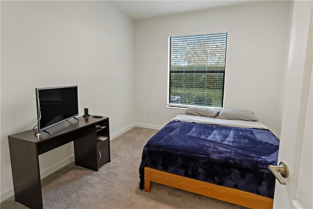 carpeted bedroom featuring baseboards