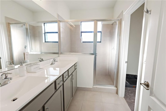 full bathroom featuring a stall shower, tile patterned flooring, a sink, and double vanity