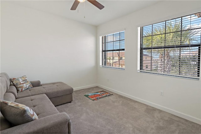 living room with ceiling fan, carpet, and baseboards