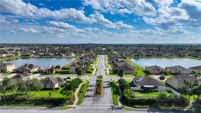 birds eye view of property featuring a water view and a residential view