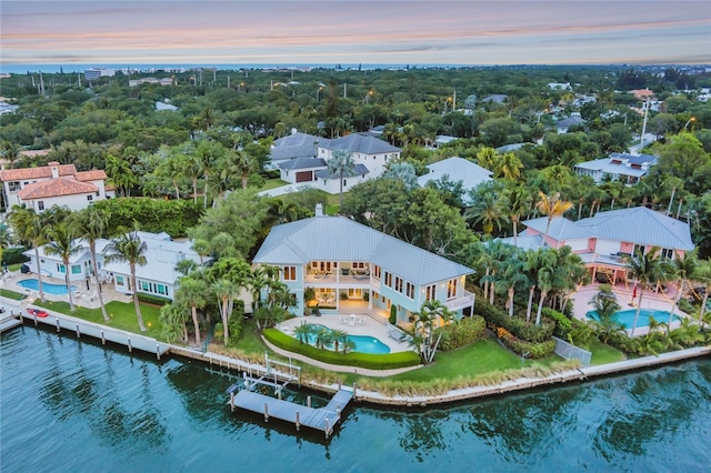 aerial view at dusk with a water view