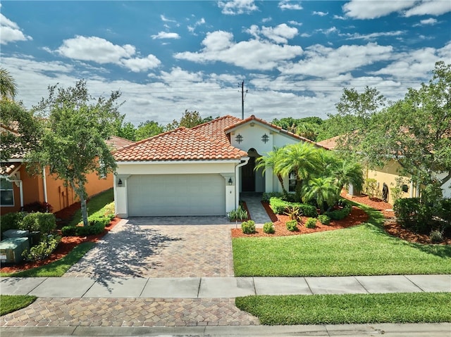 mediterranean / spanish-style house with a front yard and a garage