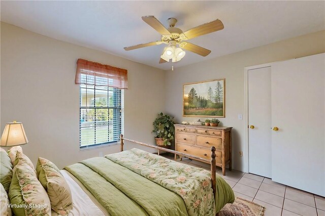 bedroom with ceiling fan and light tile patterned floors