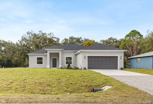 view of front of house featuring a front lawn and a garage