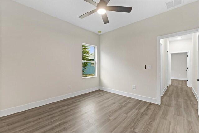 bathroom with hardwood / wood-style flooring, vanity, and walk in shower