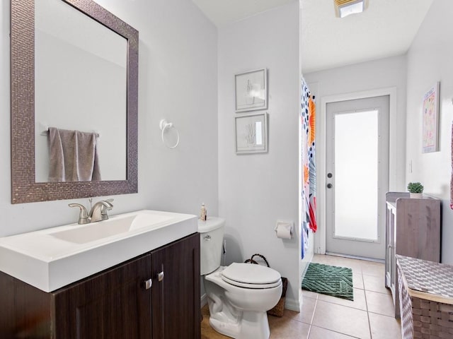 full bathroom featuring tile patterned floors, curtained shower, toilet, and vanity