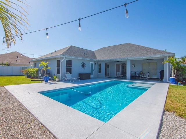 view of swimming pool with ceiling fan and a patio