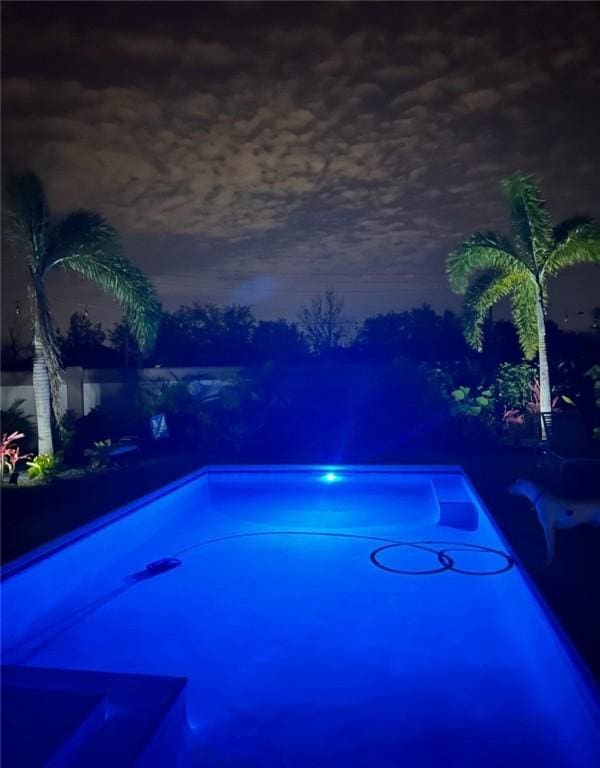 view of pool at night