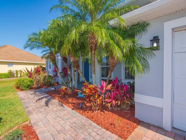 view of side of home with stucco siding