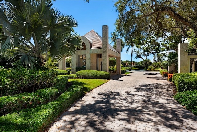 view of community with decorative driveway