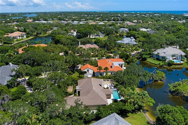 drone / aerial view featuring a water view and a residential view