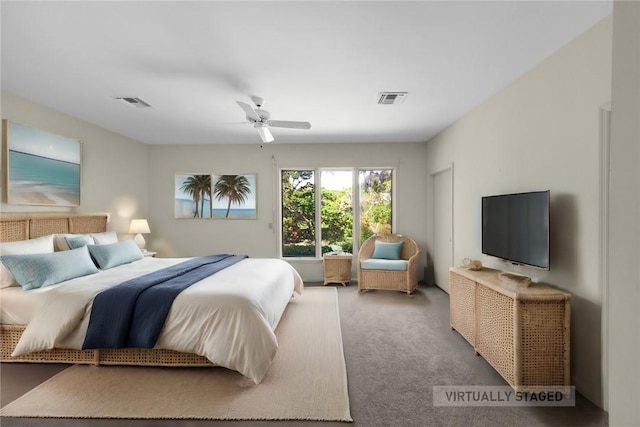 carpeted bedroom with ceiling fan and visible vents