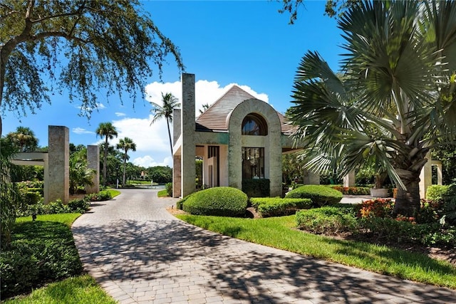 surrounding community featuring decorative driveway