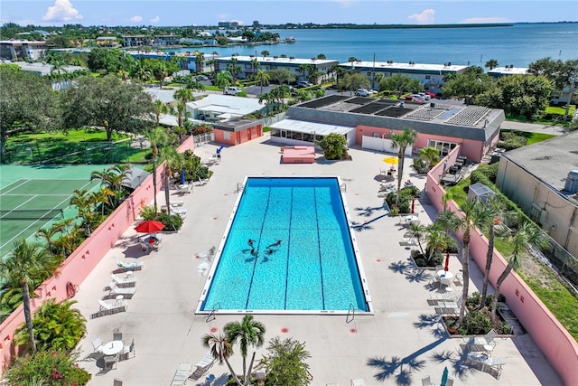 view of pool featuring a patio and a water view