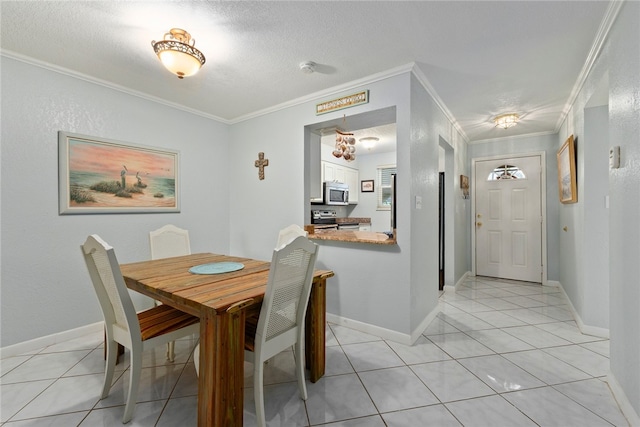 tiled dining area featuring a textured ceiling and ornamental molding