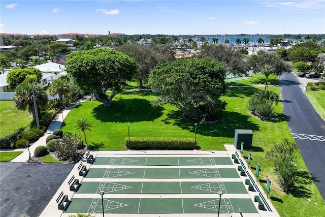 view of property's community featuring a water view and a yard