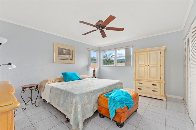 bedroom featuring a closet, light tile patterned flooring, ceiling fan, and crown molding