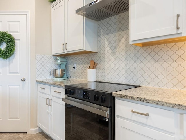 kitchen featuring light stone counters, ventilation hood, backsplash, stainless steel electric stove, and white cabinets