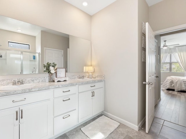 bathroom featuring hardwood / wood-style floors, vanity, ceiling fan, and an enclosed shower