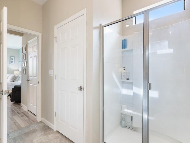 bathroom with hardwood / wood-style floors and an enclosed shower