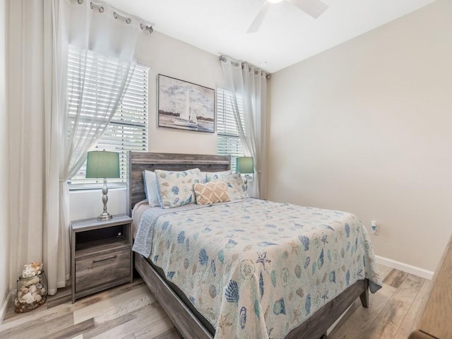 bedroom with ceiling fan and light hardwood / wood-style flooring