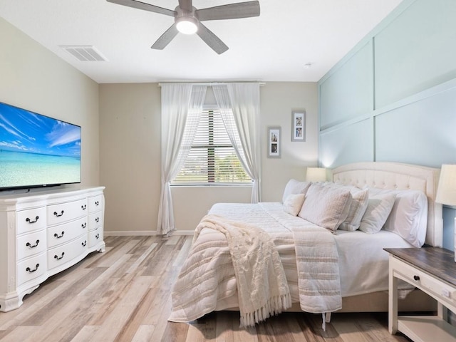 bedroom with light hardwood / wood-style floors and ceiling fan