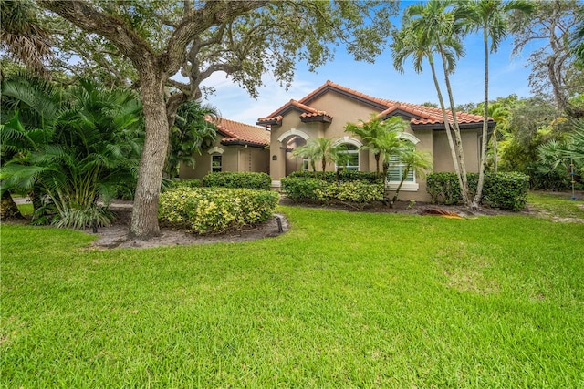 mediterranean / spanish house with a front lawn