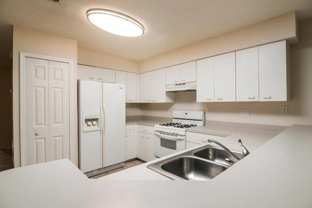 kitchen featuring white appliances, a sink, light countertops, under cabinet range hood, and white cabinetry