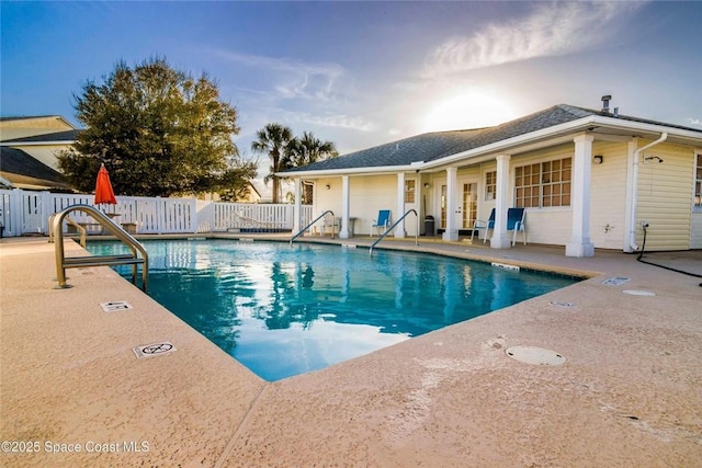 pool with fence and a patio area