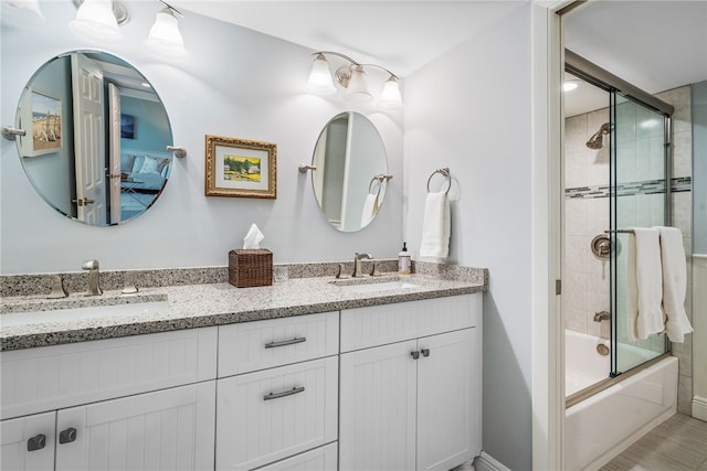 bathroom featuring vanity and enclosed tub / shower combo