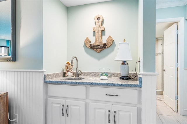 bathroom with vanity and crown molding