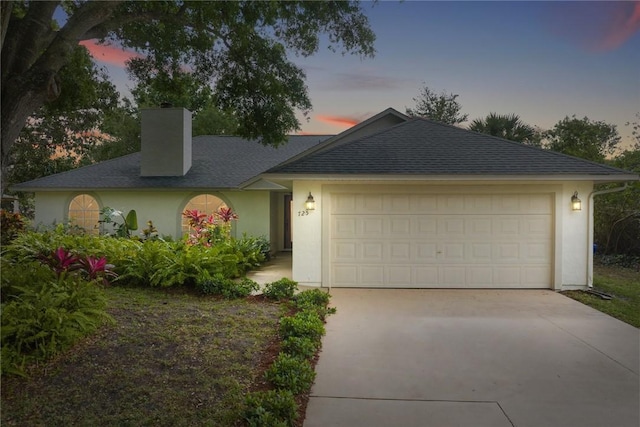 725 Wentworth St, Sebastian, FL 32958 - ranch-style house with a chimney, driveway, an attached garage, and stucco siding
