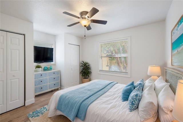 725 Wentworth St, Sebastian, FL 32958 - bedroom featuring two closets, light wood-style flooring, ceiling fan, and baseboards